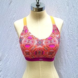 Ladies Victoria's Secret sports bra, multicolored geometric, orange criss cross